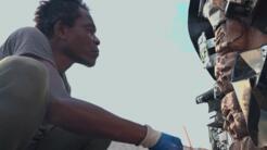 Haitian artist Celeur Jean Hérard working on a sculptor. He and his family have been displaced by gang violence and most of his artworks are stuck in the dangerous downtown area.