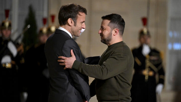French President Emmanuel Macron greets Ukrainian President Volodymyr Zelensky upon his arrival at the Élysée Palace in Paris on February 8, 2023.
