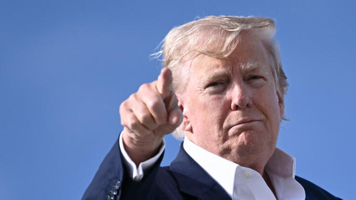 US President Donald Trump points as he boards Air Force One at RAF Lossiemouth, north-east Scotland on July 29, 2025 at the end of his trip to Scotland.