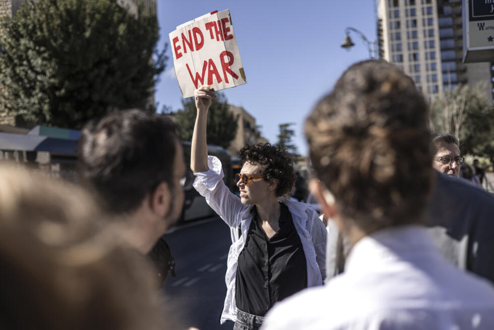 Une jeune femme brandit une pancarte lors d'une manifestation à Jérusalem contre le Premier ministre israélien Benjamin Netanyahu, appelant à la fin de la guerre à Gaza, le 19 mars 2025.