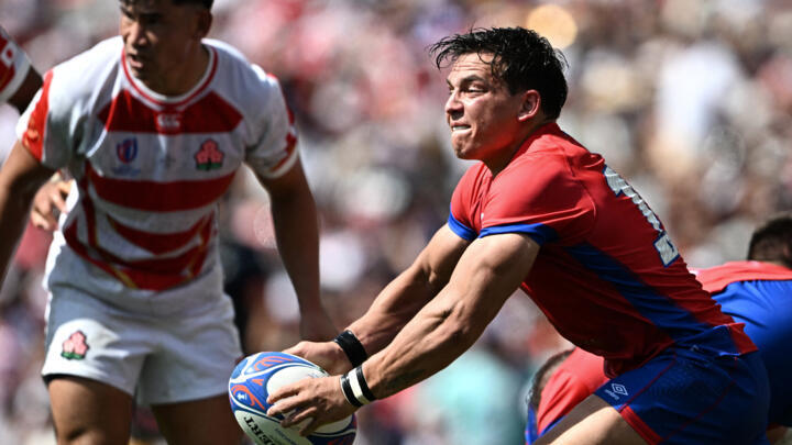 Chile's fly-half Rodrigo Fernandez (R) prepares to pass the ball during the France 2023 Rugby World Cup Pool D match between Japan and Chile at Stadium de Toulouse in Toulouse, south-western France on September 10, 2023.