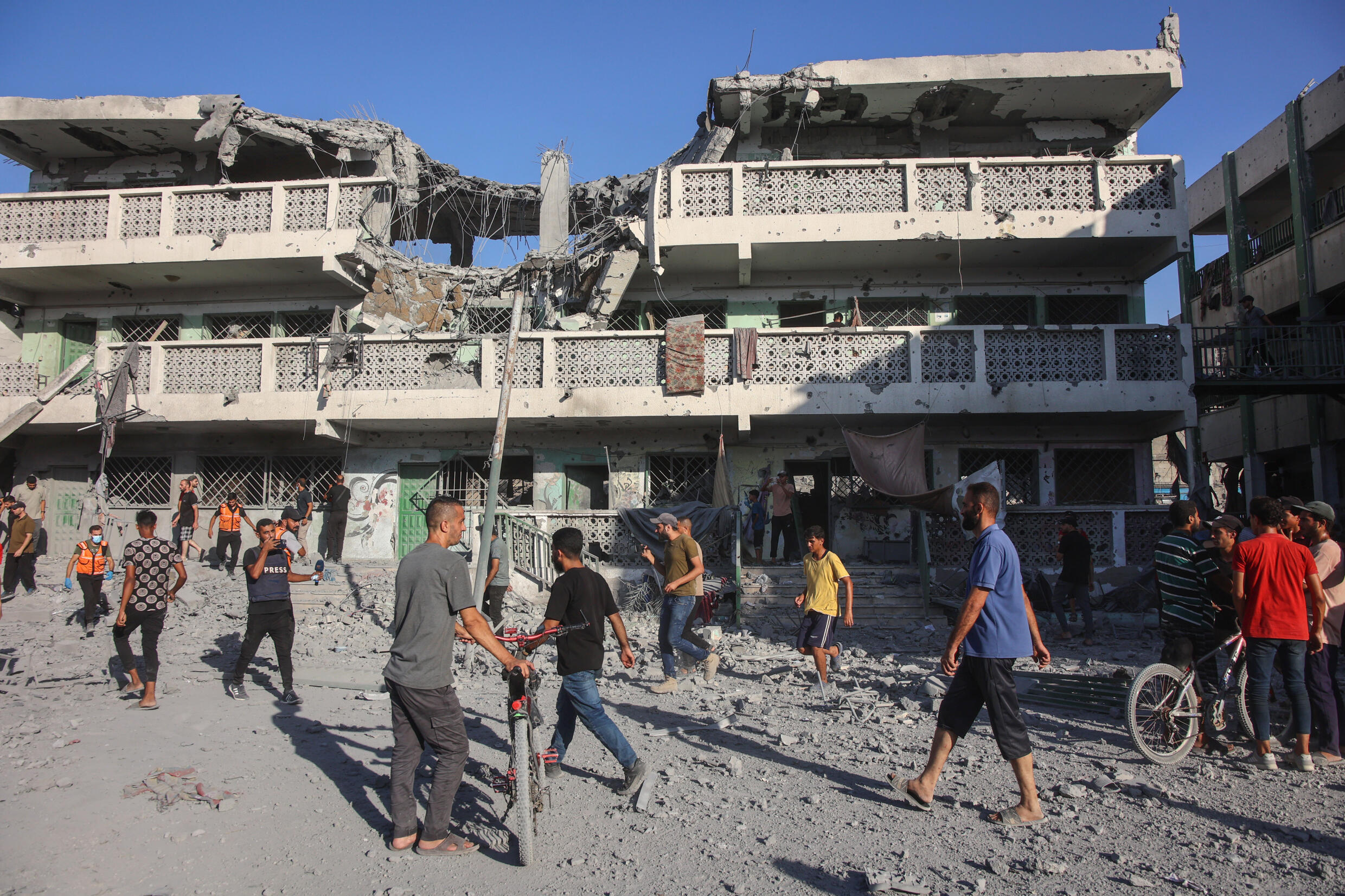 Palestinians inspect the rubble following Israeli bombardment of a school complex in Gaza City, on Saturday