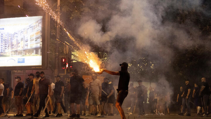A person fires fireworks, during a standoff between supporters of the ruling party and anti-government protesters in Belgrade, Serbia, August 14, 2025.