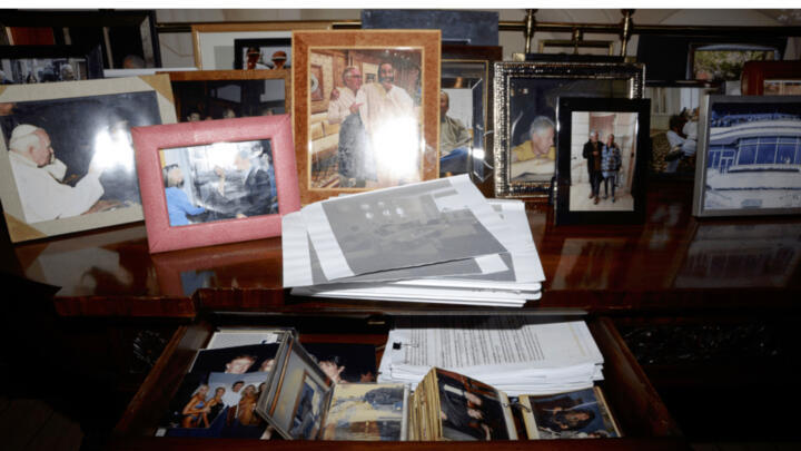 This photo released by the US Department of Justice shows a desk with a drawer open and photographs, documented on July 6, 2019, during a search of Jeffrey Epstein's home in New York