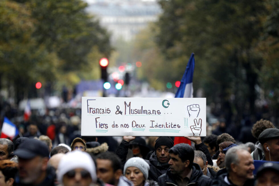 A banner reading "French and Muslim: proud of our two identities", at a rally in Paris.