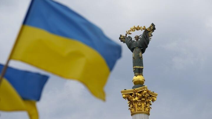 The Independence Monument is pictured as Ukrainian flags blow in the wind in Kyiv, Ukraine, on Saturday, Aug. 23, 2025.