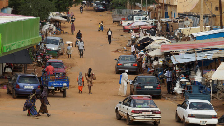 People walk on a street in Niamey, Niger on August 2, 2023. 