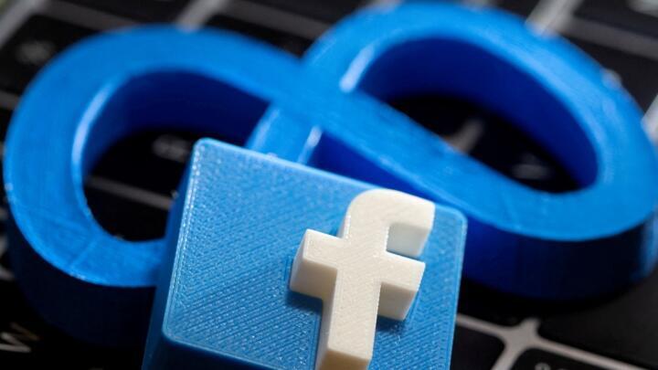 3D prints of Facebook and Meta logos are placed on a laptop keyboard in this illustration taken on November 2, 2021.