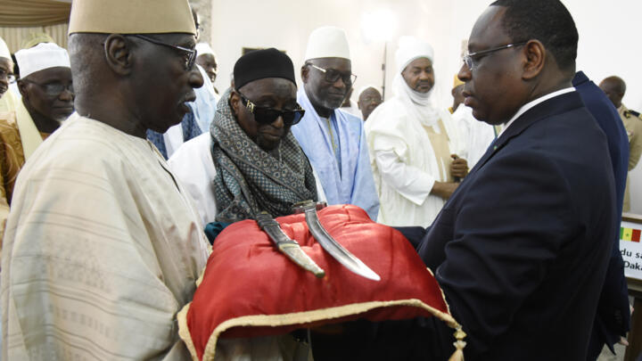 In 2019, France returned a 19th-century sword to Senegal's then-president Macky Sall (right).