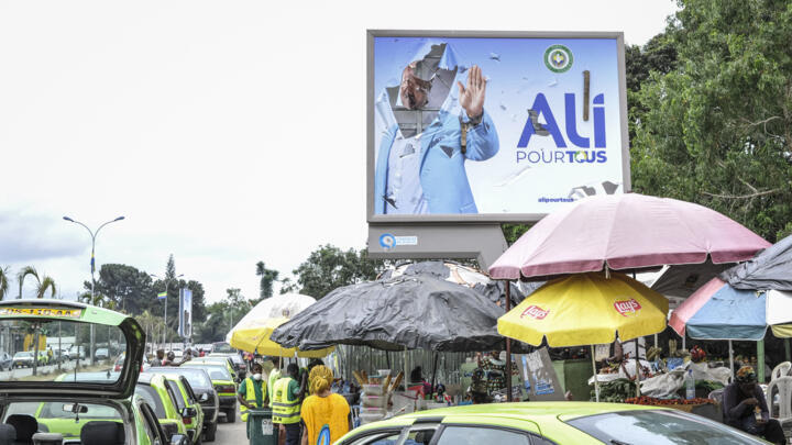 A torn campaign billboard of ousted President Ali Bongo Ondimba lines a street in Libreville, Gabon on September 1, 2023.
