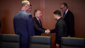 Ukraine's President Volodymyr Zelensky shakes hands with US envoy Steve Witkoff in Berlin on December 14, 2025.