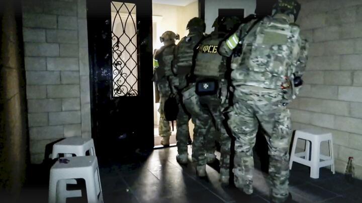FSB officers conduct an anti-terrorist operation in the Republic of Dagestan, Russia in this photo taken from video released by the National Antiterrorism Committee on June 24, 2024.