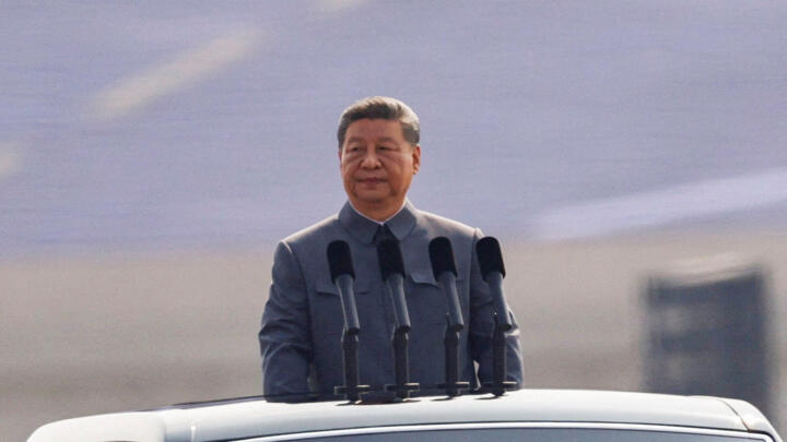 Chinese President Xi Jinping stands in a car to review the troops during a military parade to mark the 80th anniversary of the end of World War Two, in Beijing, China.
