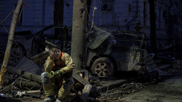 A file photo of a rescue worker resting near a university building destroyed by a Russian missile strike on Sumy, Ukraine, April 13, 2025.