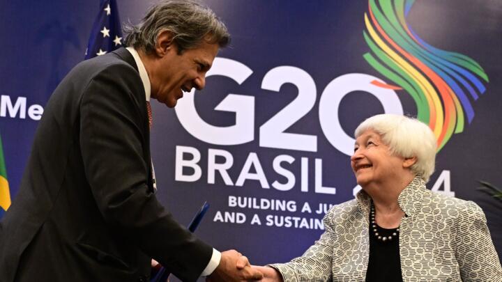 Brazil's Economy Minister Fernando Haddad (R) shakes hands with US Treasury Secretary Janet Yellen during the G20 economic ministers' meeting in Rio de Janeiro, Brazil, on July 26, 2024.