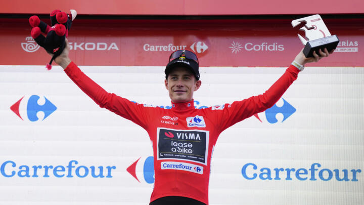 Danish cyclist Jonas Vingegaard, wearing red, on the podium of the 19th stage of the Vuelta, in Guijuelo, Spain, on September 12, 2025.