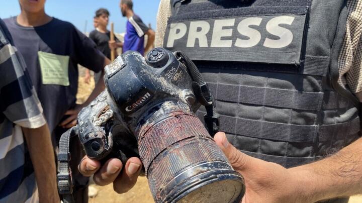 A journalist holds the blood-covered camera belonging to Palestinian photojournalist Mariam Dagga, a journalist killed in an Israeli strike on Nasser hospital in Khan Yunis in the southern Gaza Strip.