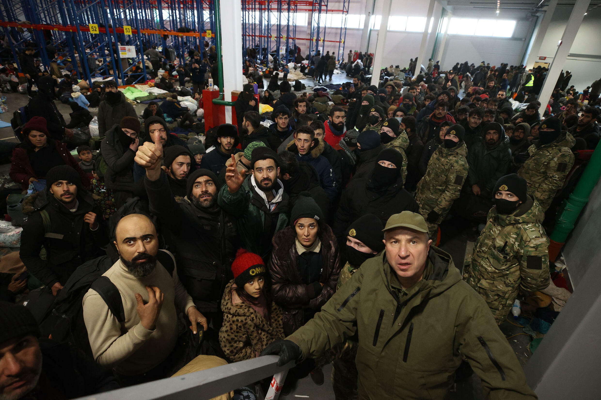 Migrants at a Belarusian logistics centre near the country's border with Poland