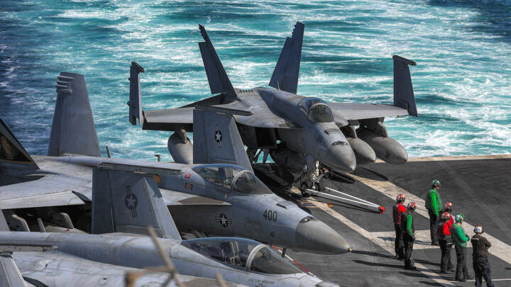 US Navy F/A-18 Hornet multirole combat aircraft are pictured on the deck of the aircraft carrier USS Dwight D. Eisenhower transits the Strait of Hormuz on November 26, 2023. 