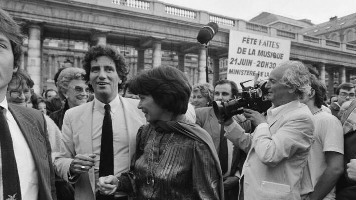 In this file photo taken on June 21, 1982, French Culture minister Jack Lang (L), French first lady Danielle Mitterrand (C), French film director François Reichenbach (R) and French producer Christine Gouze-Renal (background L) attend the first edition of the annual music event "Fête de la Musique" at the Palais Royal in Paris.