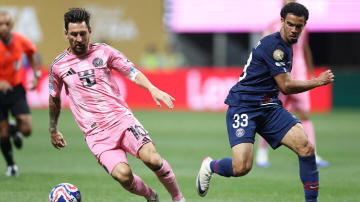 Inter Miami's Lionel Messi and Paris Saint-Germain's Warren Zaire-Emery fight for the ball during the FIFA Club World Cup 2025 round of 16 football match between France's Paris Saint-Germain and US In