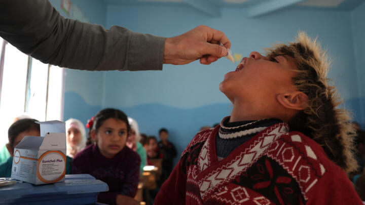 A medic gives the cholera vaccination to a child during a vaccination campaign in the town of Maaret Misrin in the rebel-held northern part of the northwestern Idlib province on March 7, 2023.