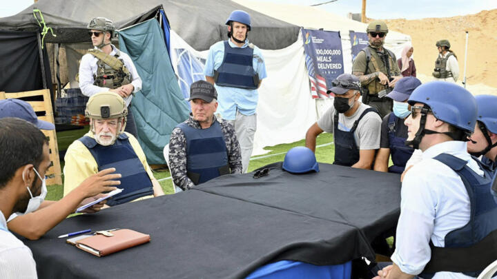 This handout photo from US Embassy Jerusalem shows White House special envoy Steve Witkoff, center, and US Ambassador to Israel Mike Huckabee, center left, visiting a food distribution site