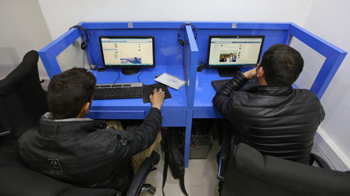 [File photo]  Afghanis access social media websites at a private internet cafe in Kabul on February 10, 2016.