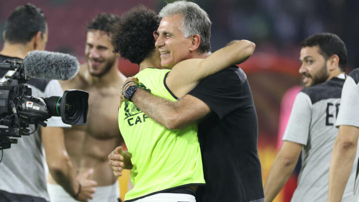 Egypt coach Carlos Queiroz celebrates with Mohamed Salah after their penalty shoot-out win over Cameroon.