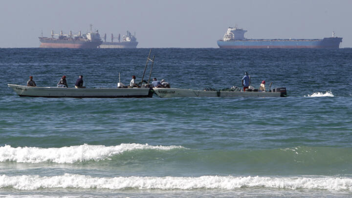 [File photo] Fishing boats are seen in front of oil tankers south of the Strait of Hormuz on January 19, 2012.