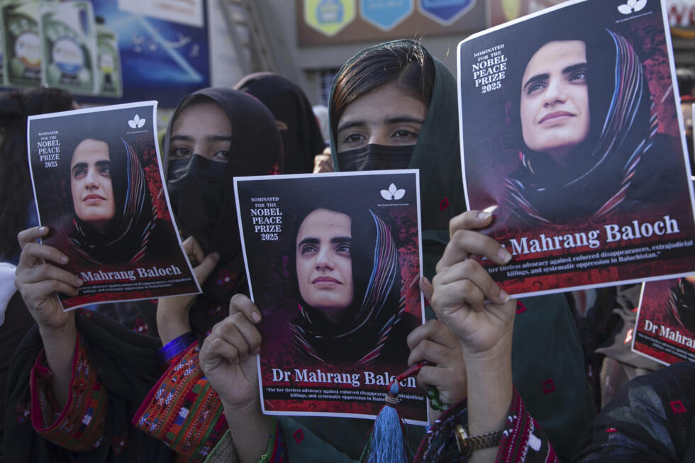 Activists hold up posters depicting Mahrang Baloch, a Baloch human rights activist, during a demonstration calling for his release in Karachi, Pakistan, on March 24, 2025.