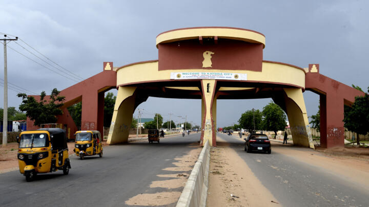 Taxi rick-shaws drive past Katsina State city gate in northwest Nigeria, on July 20, 2022