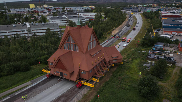 L'église en bois de Kiruna est transférée vers son nouvel emplacement grâce à une plateforme à roulettes, en Suède, le 20 août 2025.
