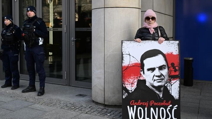 File photo of a demonstrator holding a poster to free Belarusian journalist Andrzej Poczobut taken in front of the European Parliament office in Warsaw, March 14, 2024