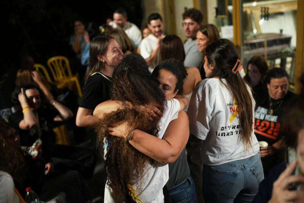 Familiares y simpatizantes de los rehenes en poder de Hamás se abrazan para celebrar la firma del acuerdo de paz que permitirá la liberación de los cautivos. Tel Aviv, 9 de octubre de 2025.