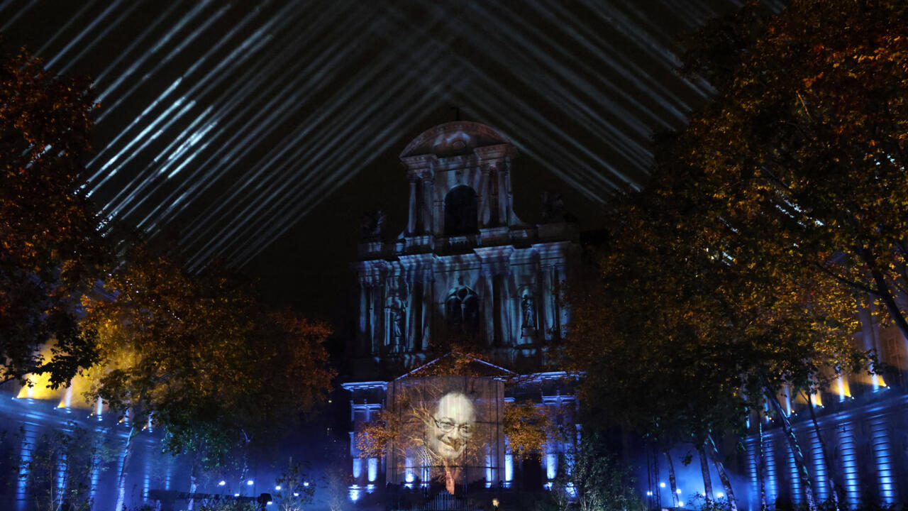 Photos of victims of the November 13, 2015, attacks are projected during a ceremony at the "Jardin du 13 novembre 2015" in Paris on November 13, 2025.