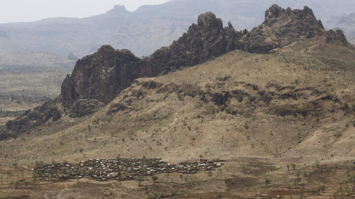 A picture taken from a helicopter on June 19, 2017 shows an aerial view of the war-torn town of Golo in the thickly forested mountainous area of Jebel Marra in central Darfur.