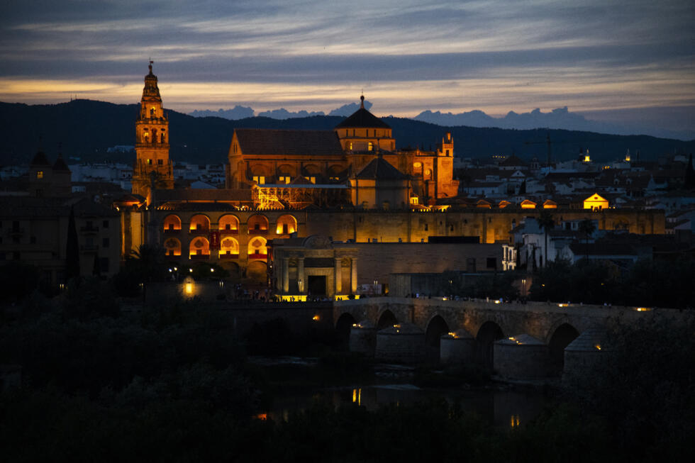 The Mosque-Cathedral of Cordoba is pictured next to the Roman bridge on June 11, 2023.
