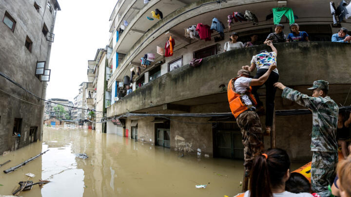 Rescuers transfer residents with a boat at a flooded area in Guilin
