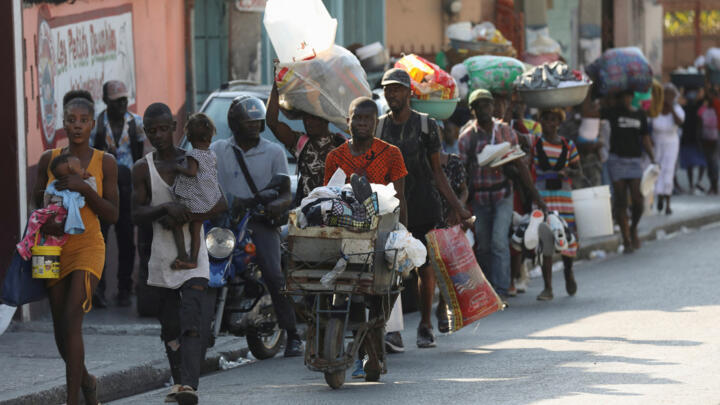 People flee their homes as police confront armed gangs after prominent gang leader Jimmy Cherizier called for Haiti's Prime Minister Ariel Henry's government to be toppled, February 29, 2024.