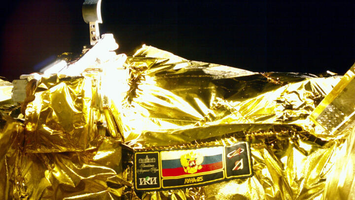 A picture taken from the camera of the lunar landing spacecraft Luna-25 during its flight to the moon shows the mission emblem and the bucket of the lunar manipulator complex, August 15, 2023. 