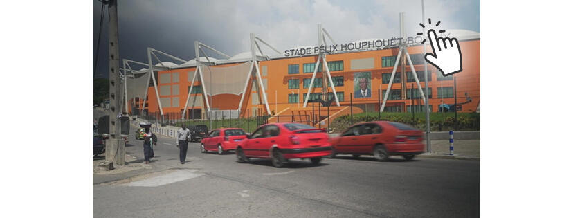 Illustration de voitures devant le stade Houphouët Boigny en Côte d'Ivoire.