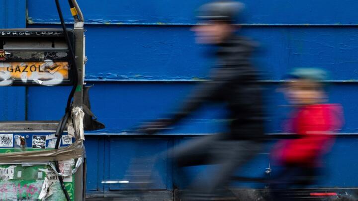 A cyclist rides past an abandoned diesel fuel pump, in Paris, on March 13, 2022.