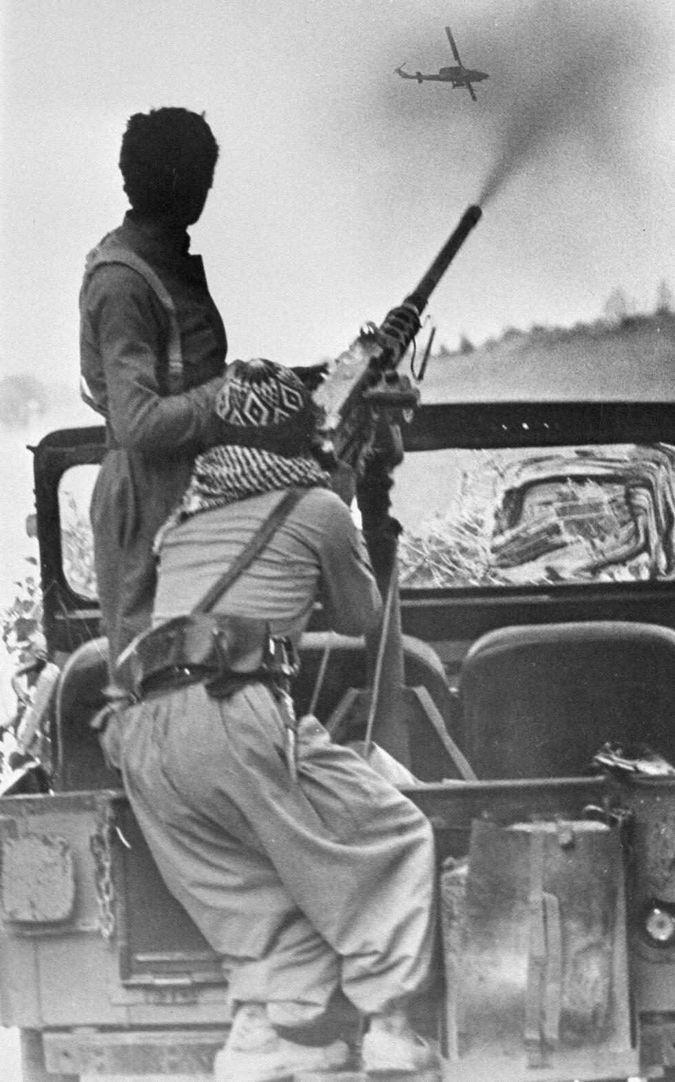 Kurdish rebels fire at a government forces helicopter gunship on the outskirts of the embattled town of Saqqez, Iran, Aug. 27, 1979.
