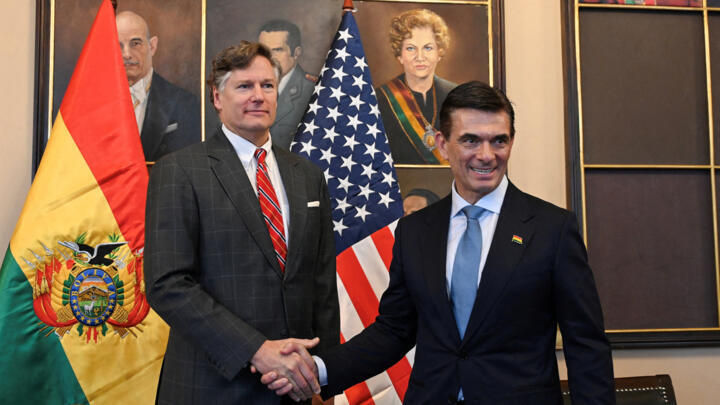 Bolivia's President Rodrigo Paz and US Deputy Secretary of State Christopher Landau shake hands, after the swearing-in ceremony of the Bolivian President, in La Paz, Bolivia, November 8, 2025. 