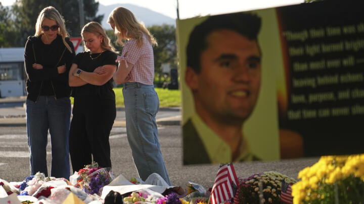 Women pray at a memorial outside Utah Valley University after Turning Point USA CEO and co-founder Charlie Kirk was shot and killed, Saturday, September 13, 2025, in Orem, Utah. 