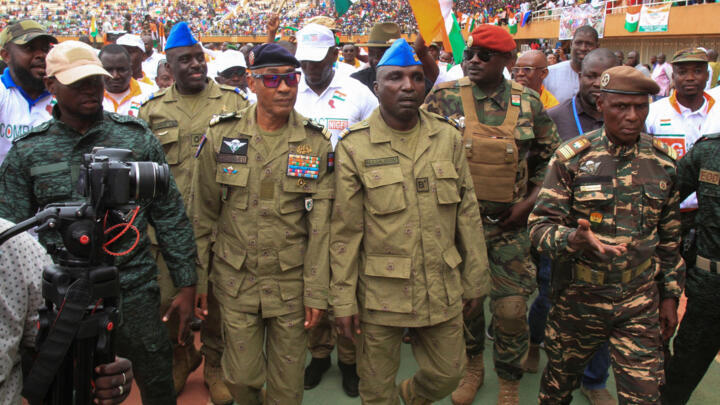 Nigeriens junta leaders walk while Nigeriens gather one month since coup, in support of the putschist soldiers and to demand French ambassador to leave, in the capital Niamey, Niger August 26, 2023.