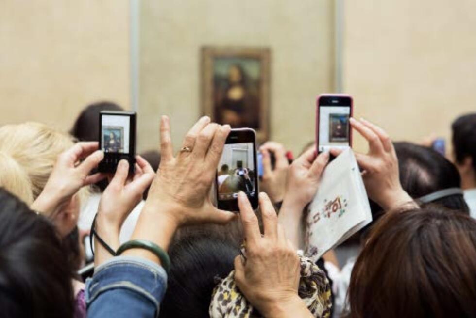 A Martin Parr photograph showing visitors at the Louvre museum clamouring to take photos of the Mona Lisa on their smart phones.