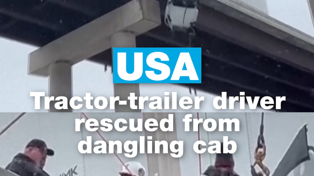 USA: Tractor-trailer driver rescued from a cab dangling over a bridge