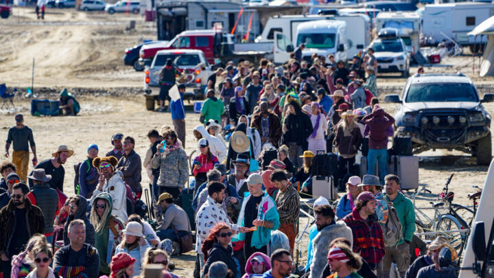 Hundreds of Burning Man attendees who planned to leave on buses wait for information about when they will be able to leave on Labor Day, after a rainstorm turned the site into mud September 4, 2023.